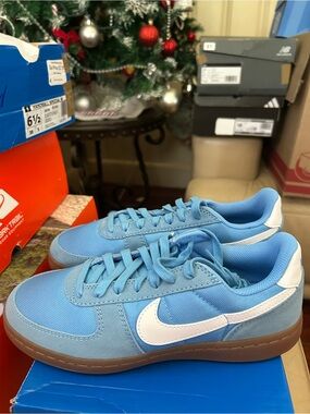 Nike Light Blue Low-Top Sneakers with White Swoosh and Brown Sole